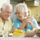 Senior Couple Eating Meal Together In Kitchen