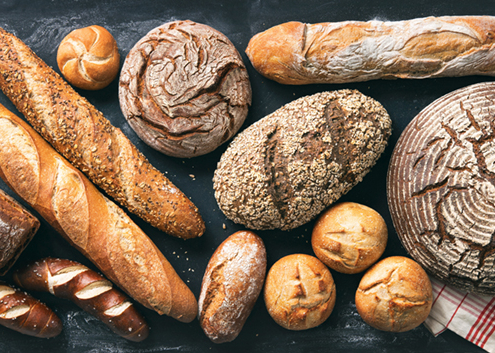 Delicious freshly baked bread assortment on dark rustic background