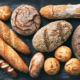 Delicious freshly baked bread assortment on dark rustic background