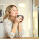 Woman breathing holding a coffee mug at home